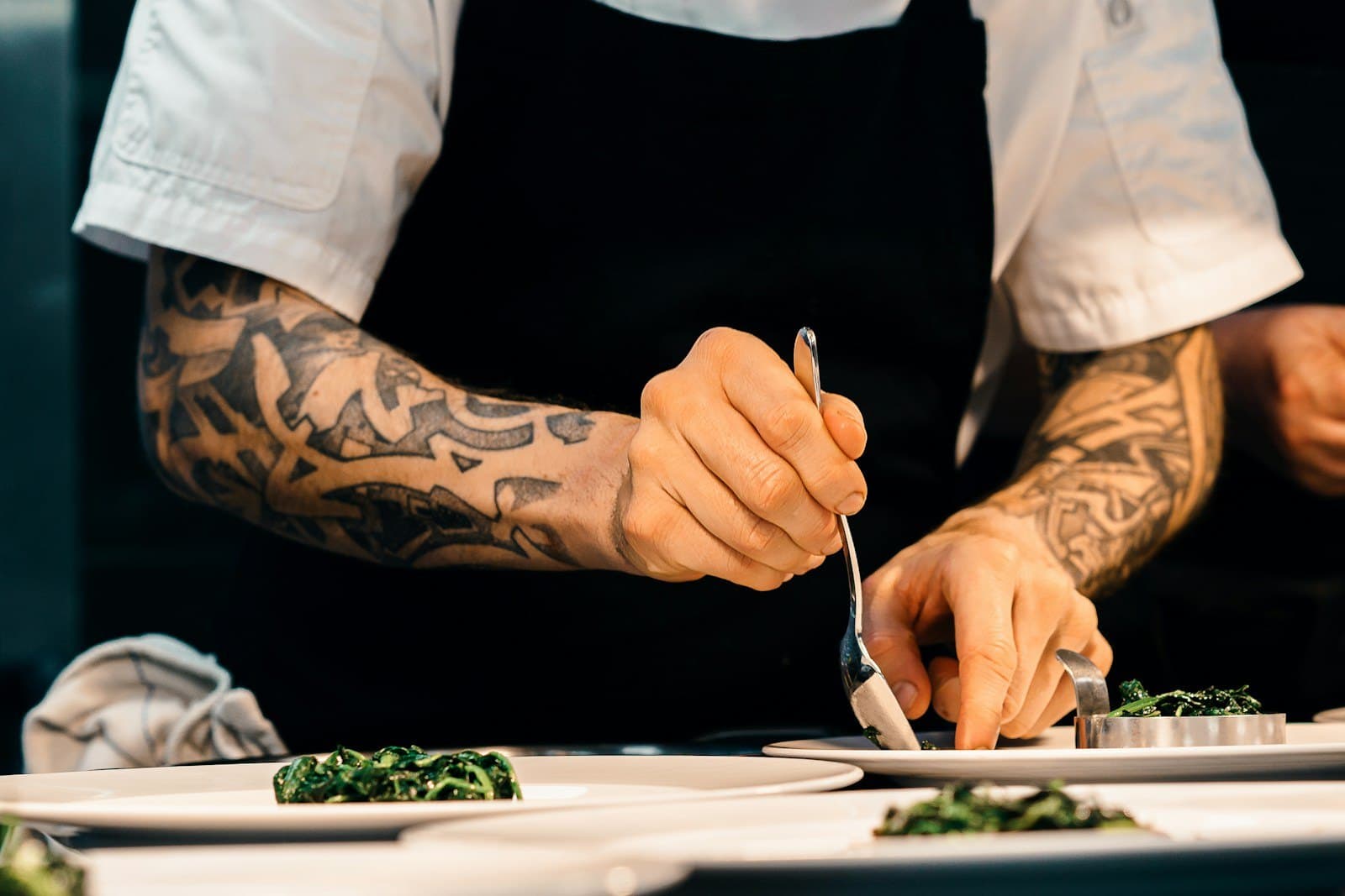 Chef finishing a plate in the Najdi Table kitchen